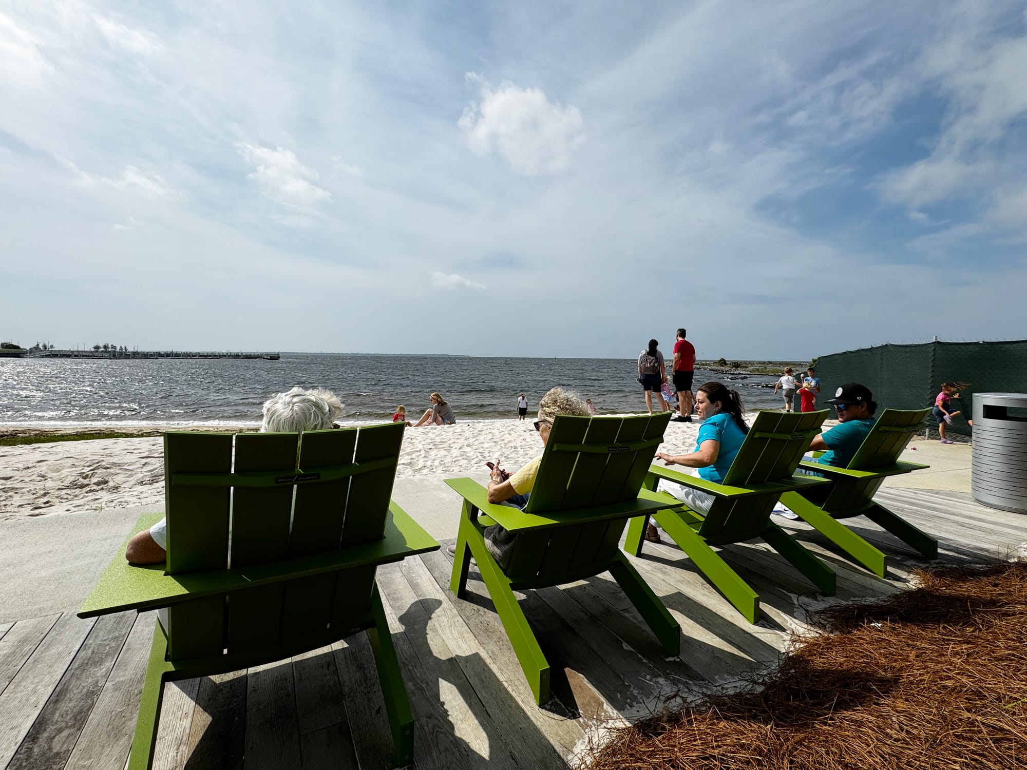 Adirondack chairs along the Bruce Beach waterfront on Pensacola Bay.